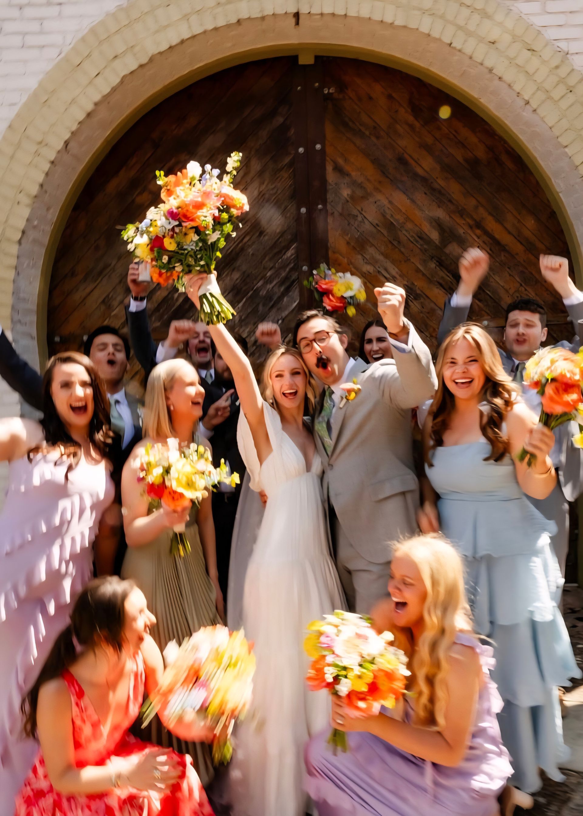 cheering bride, groom, and wedding party