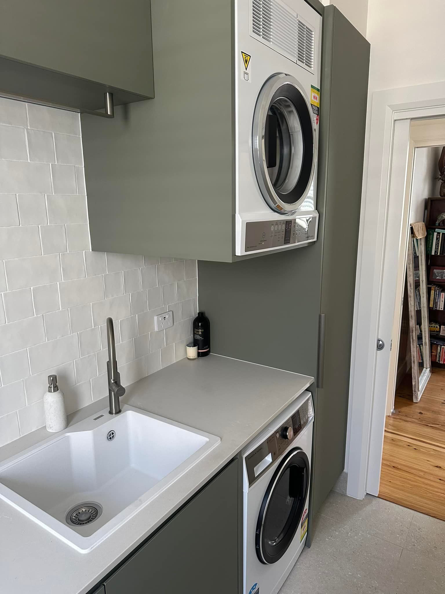 A Laundry Room With a Washer and Dryer and a Sink — Kenross Kitchens In Erina, NSW
