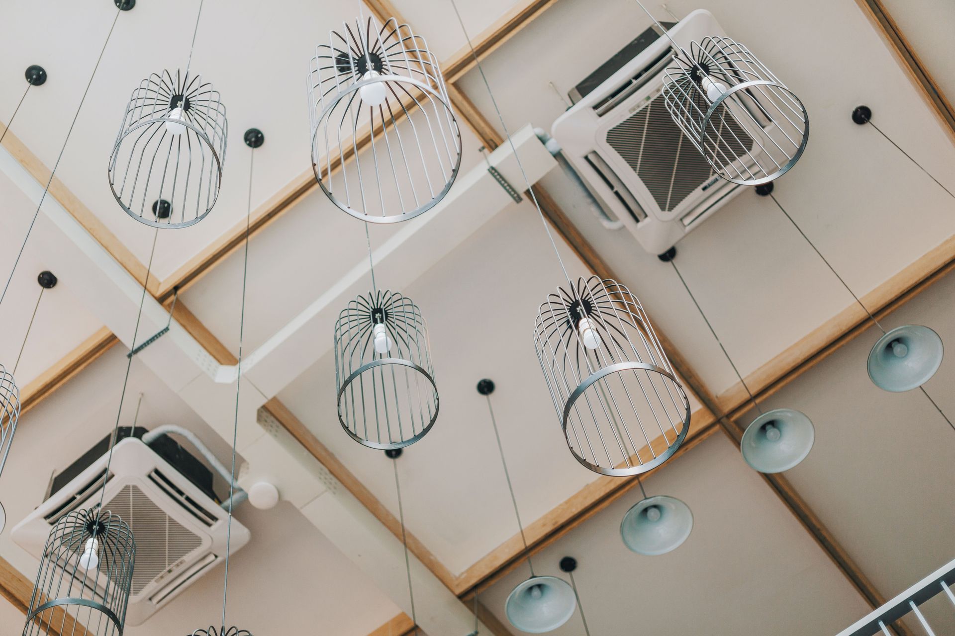 Ceiling cassette air conditioner with recessed lights and a window blind below