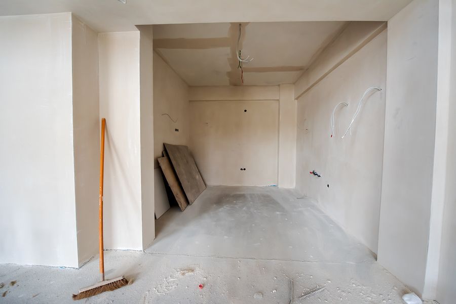 an empty room with a broom in it