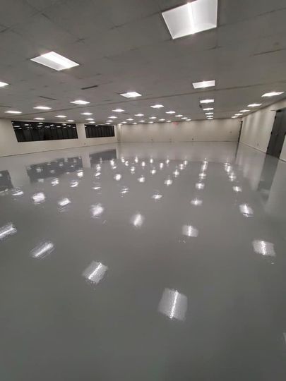 Empty glossy indoor hall with white ceiling lights reflecting on the floor
