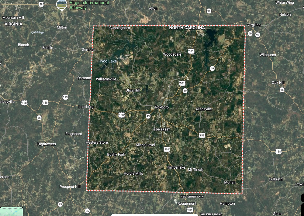 Satellite map showing a forested area outlined by a red square boundary on a rural landscape.