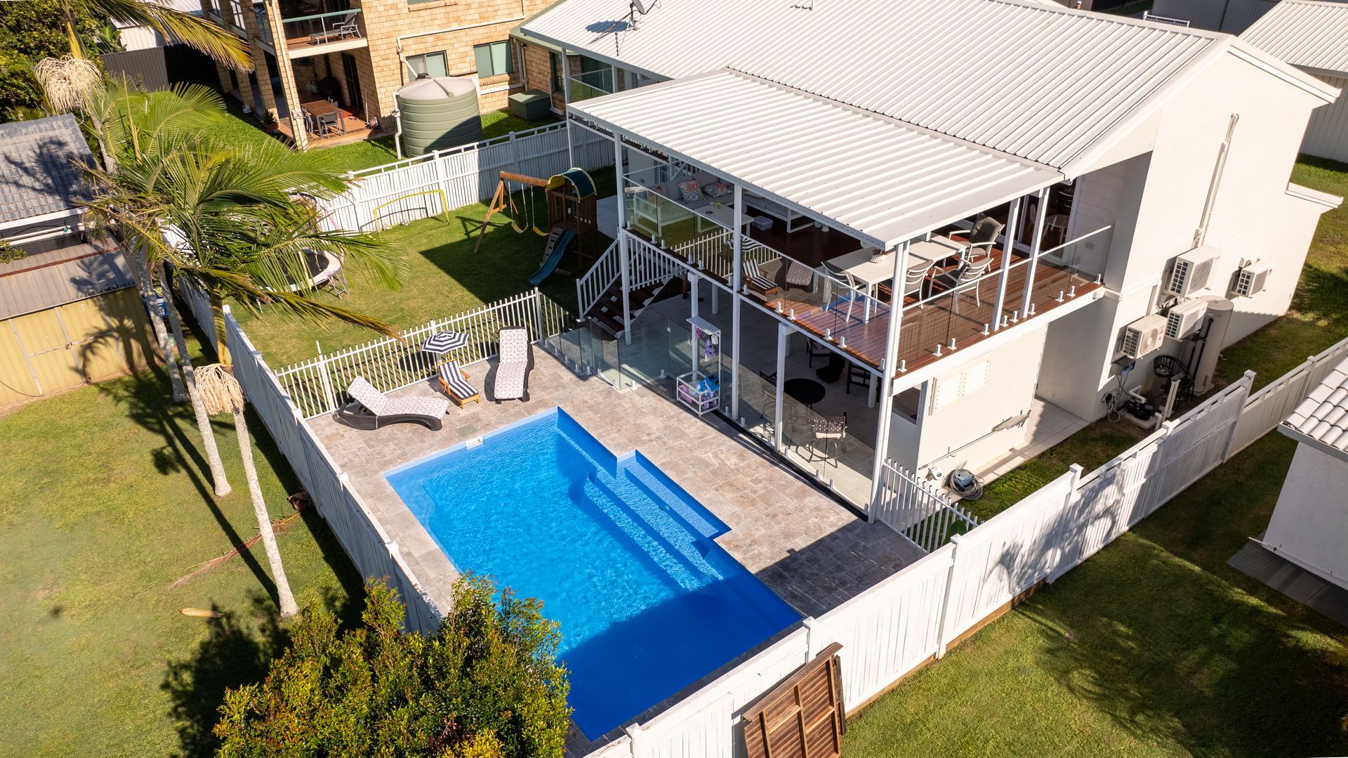 Infinity pool with turquoise water beside a white stone deck