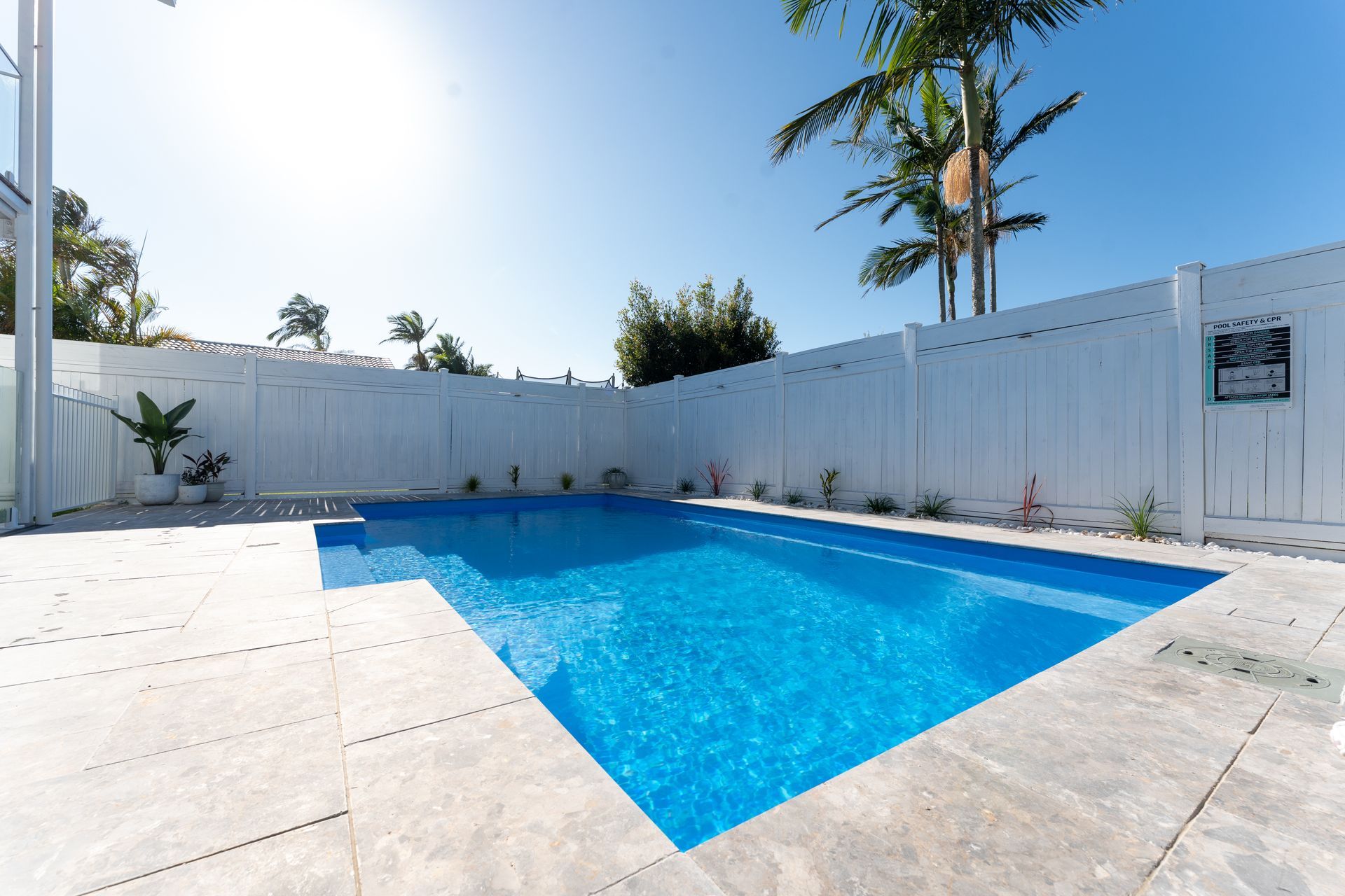 Pool ladder at the edge of a turquoise indoor swimming pool