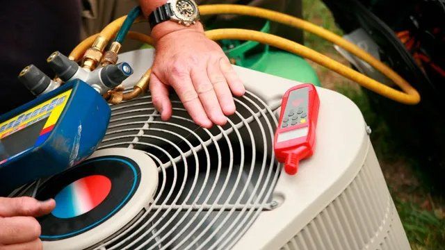 A technician's hand checking an air conditioner unit with tools, including gauges and a temperature reader, likely for maintenance.