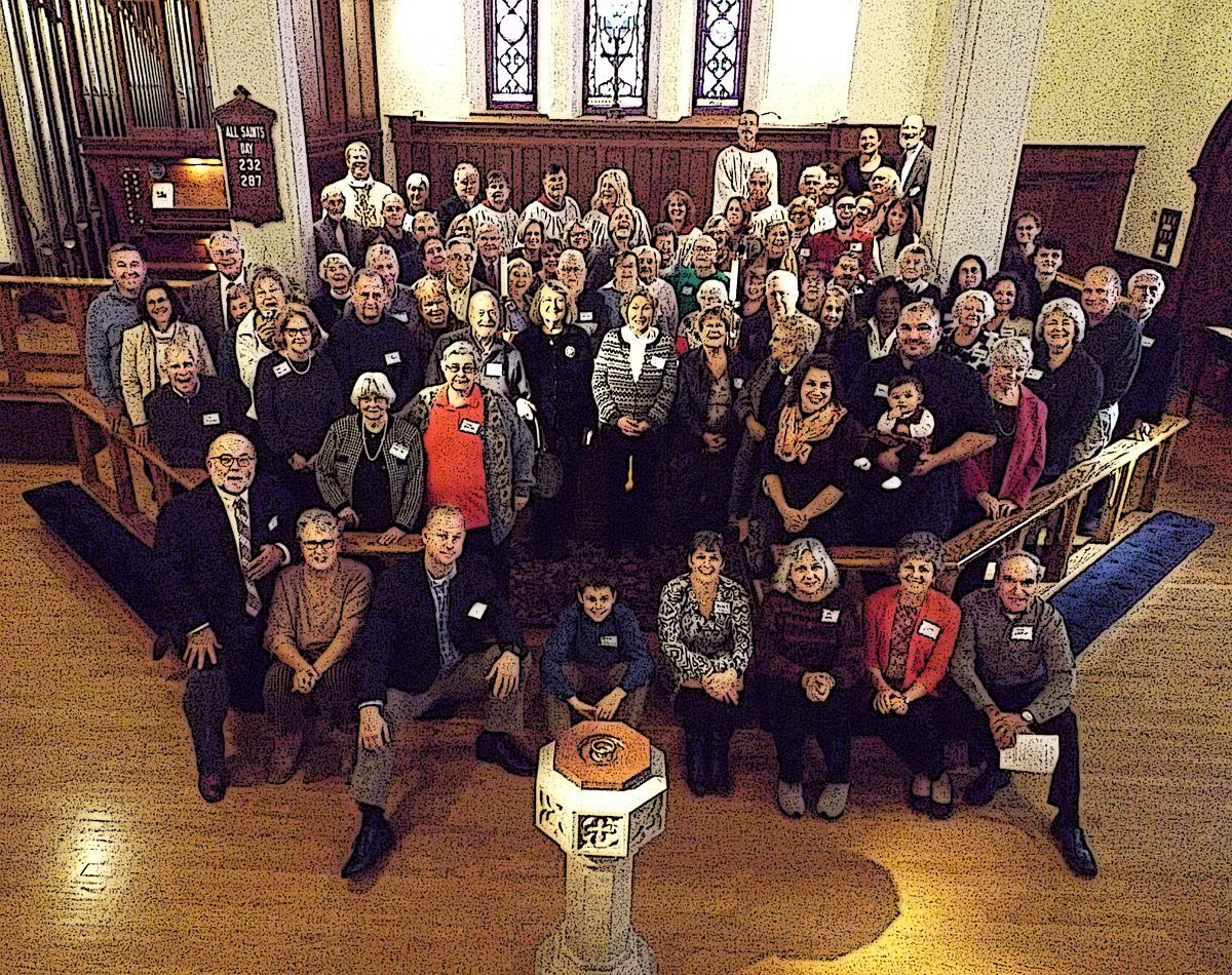 The Congregation poses together on the altar inside of Grace Church's softly lit chapel on All Saints Day 2018