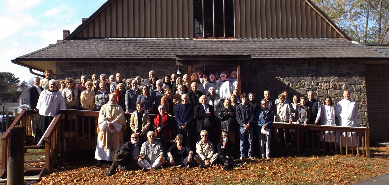 The Congregation poses together outdoors on Grace Church's side ramp in partial sunlight on All Saints Day 2023