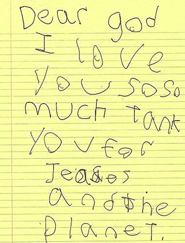 A child's handwritten note scrawled on yellow lined paper: “Dear God I love you so so much thank you for Jesus & the planet.”