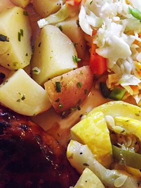 Assorted potato salad w/diced  fresh vegetables rests on a plate