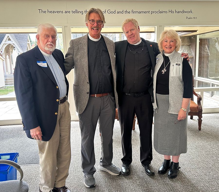 Four clergy members pose in a line together, in our daylight-lit lobby/entryway