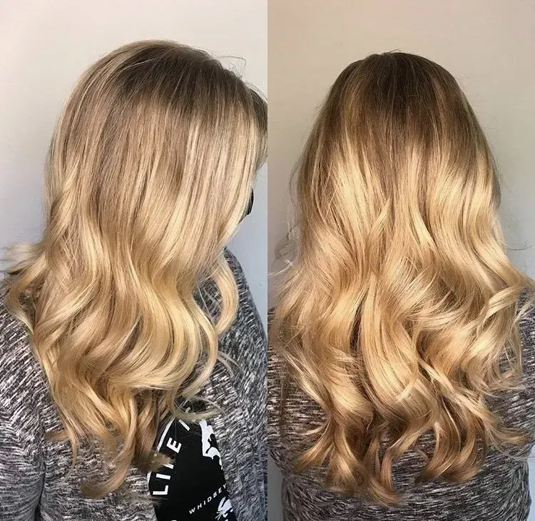 Blonde wavy hair shown from side and back, with soft curls and darker roots.