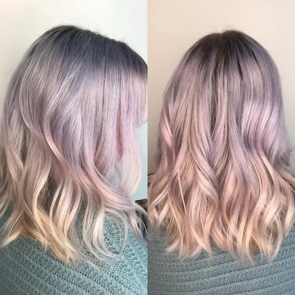 Back and side views of shoulder-length wavy pastel pink and lavender hair on a teal sweater.