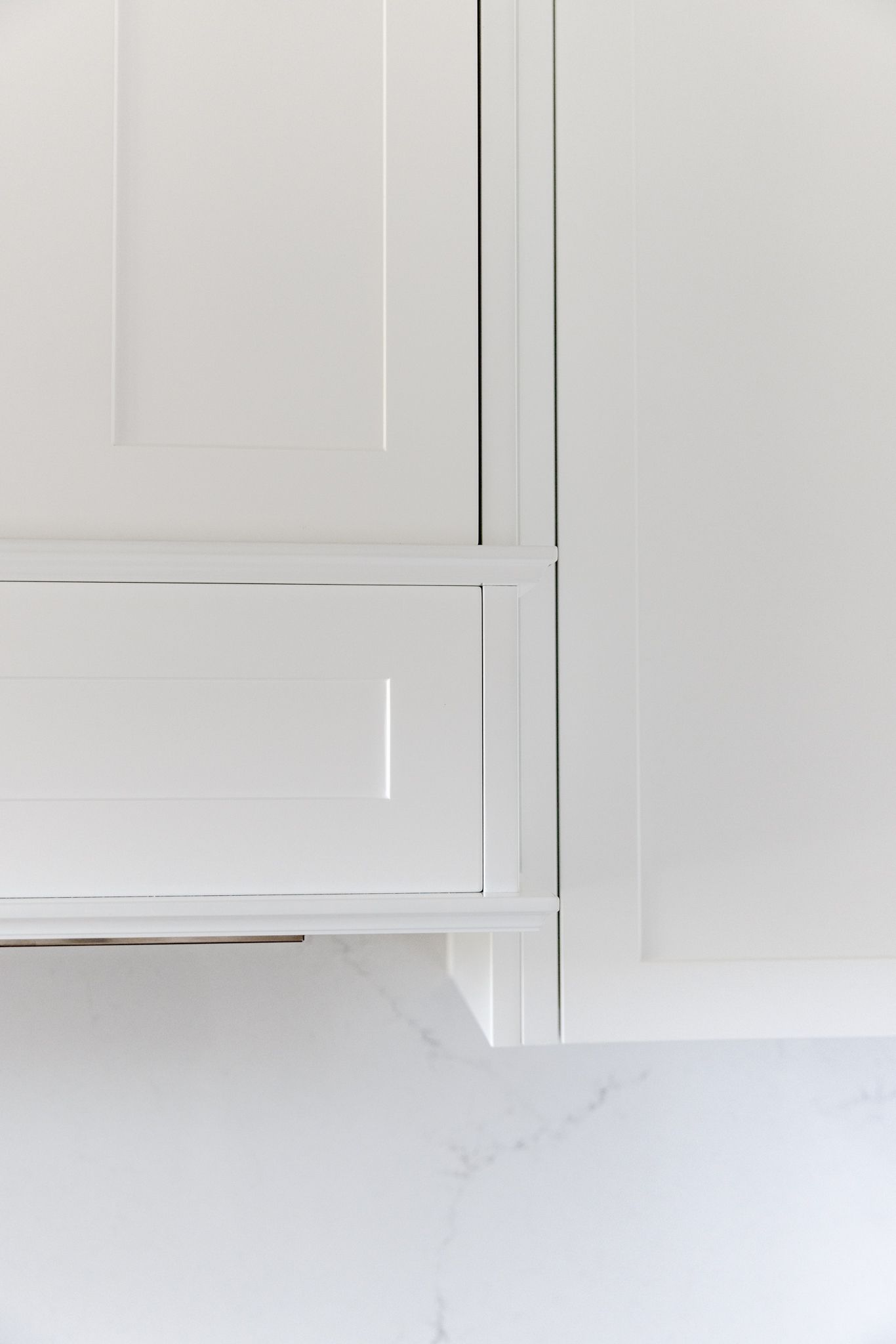 A close-up of a locally manufactured custom white shaker style rangehood joinery.
