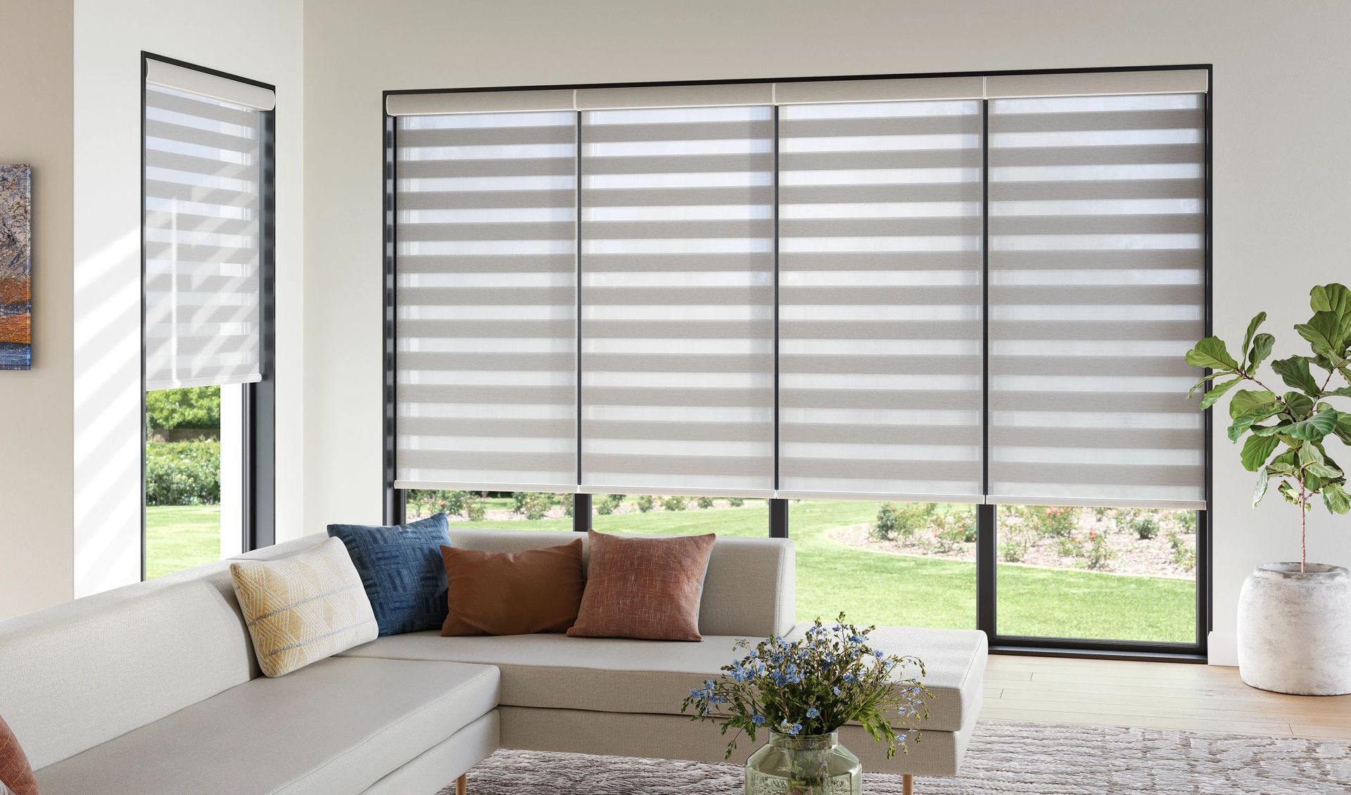 A living room with a couch and striped blinds on the windows.
