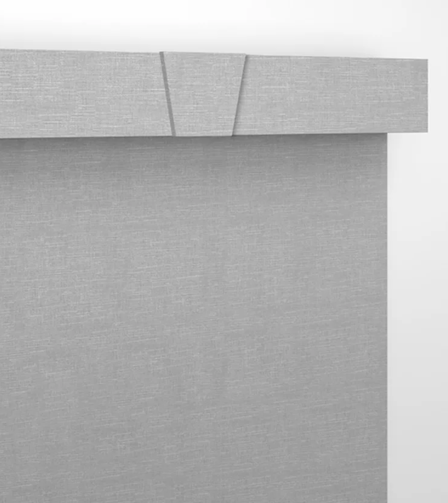 A close up of a gray curtain on a white wall.