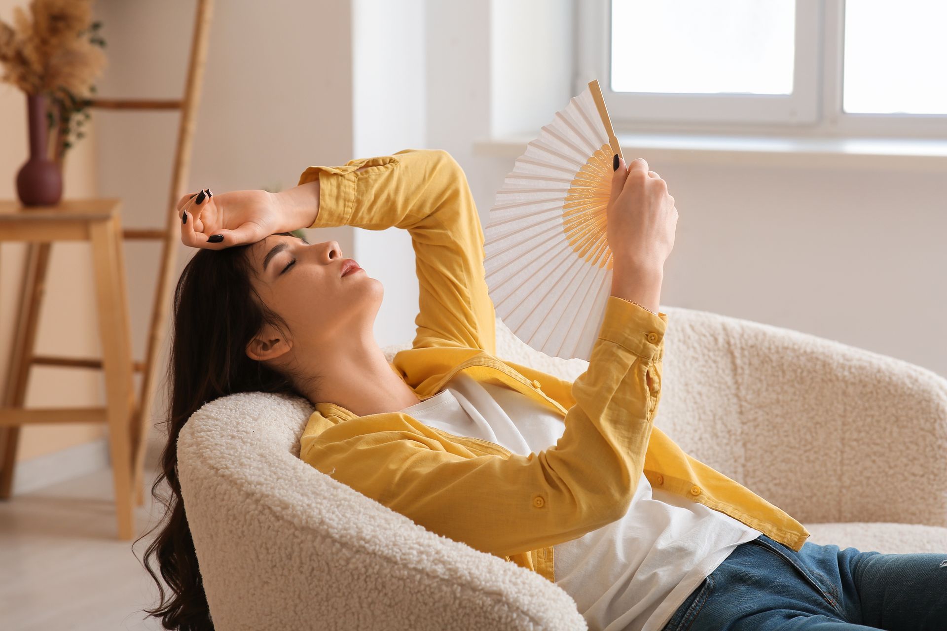 woman hot on couch during heatwave