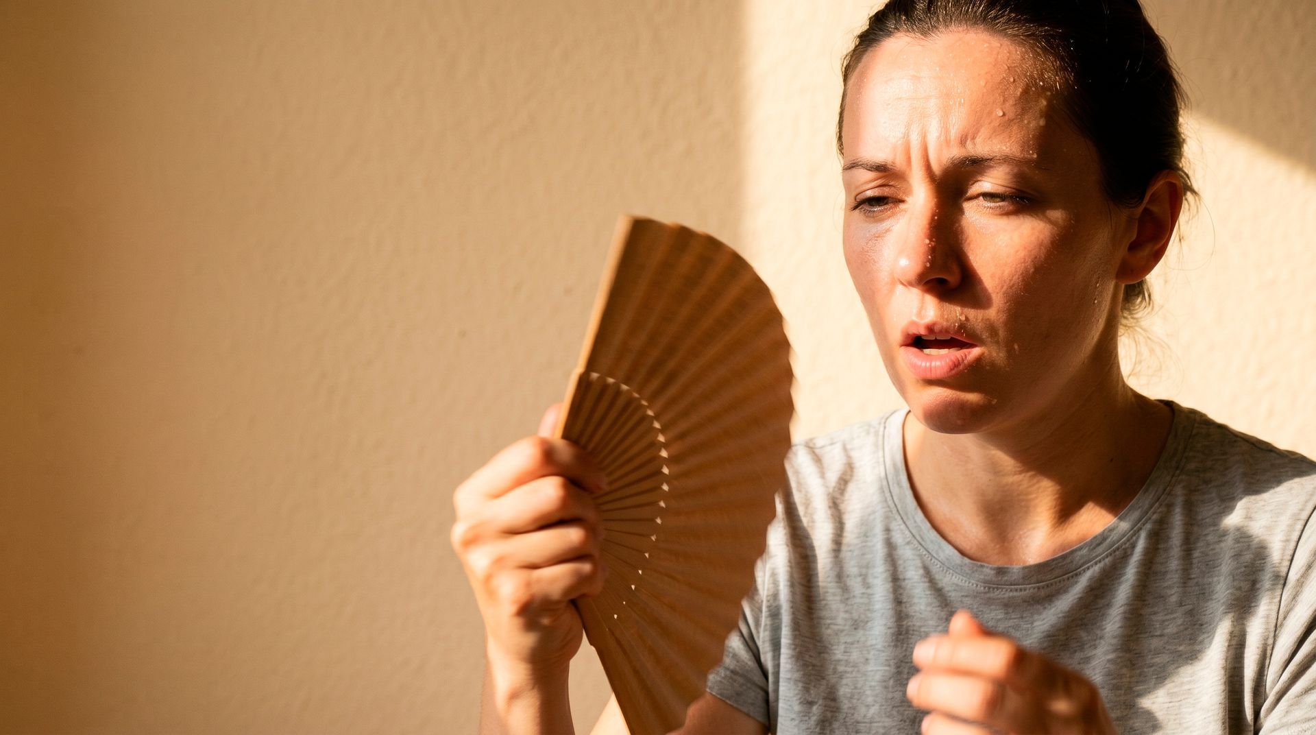 woman fanning face