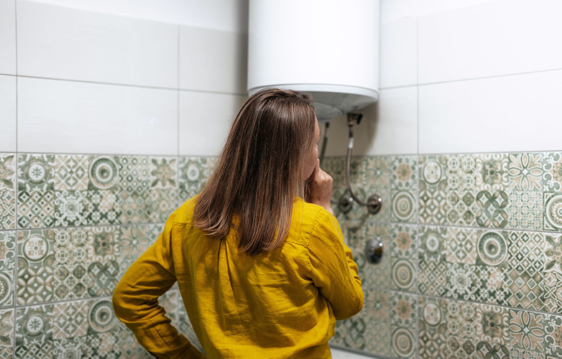 woman concerned with water heater