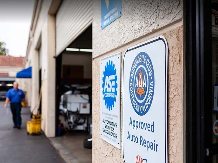 Auto repair shop entrance with blue and white certification signs on the wall. | Westlake Independent Automotive