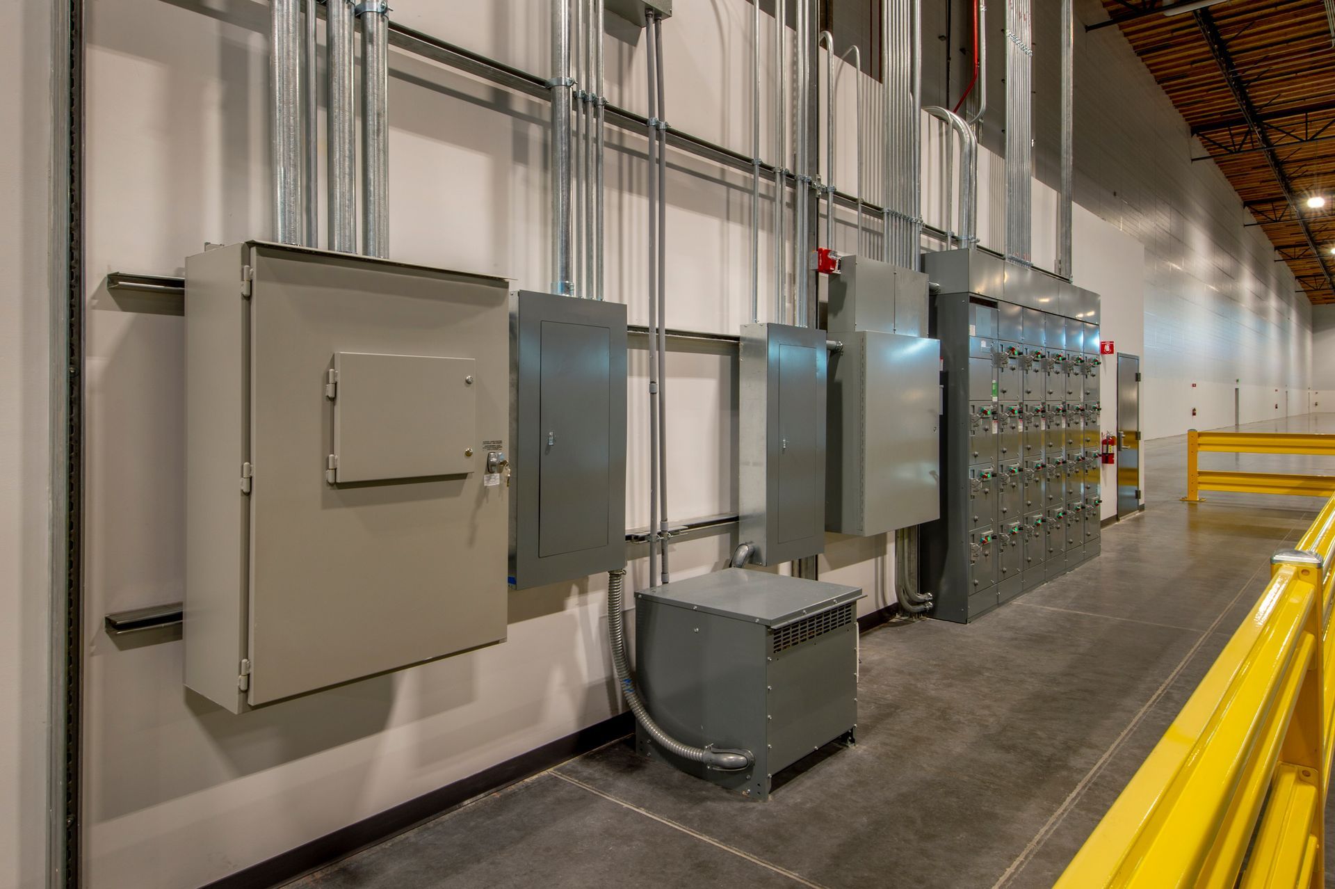 A warehouse with a lot of electrical boxes on the wall.
