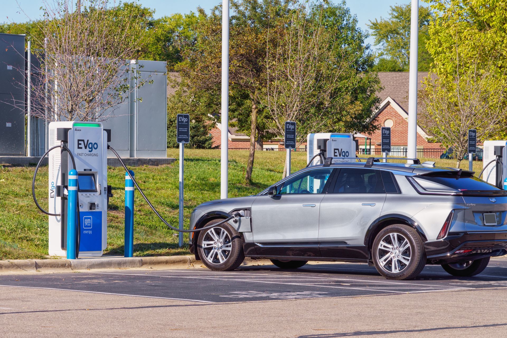 An electric car is being charged at a charging station.