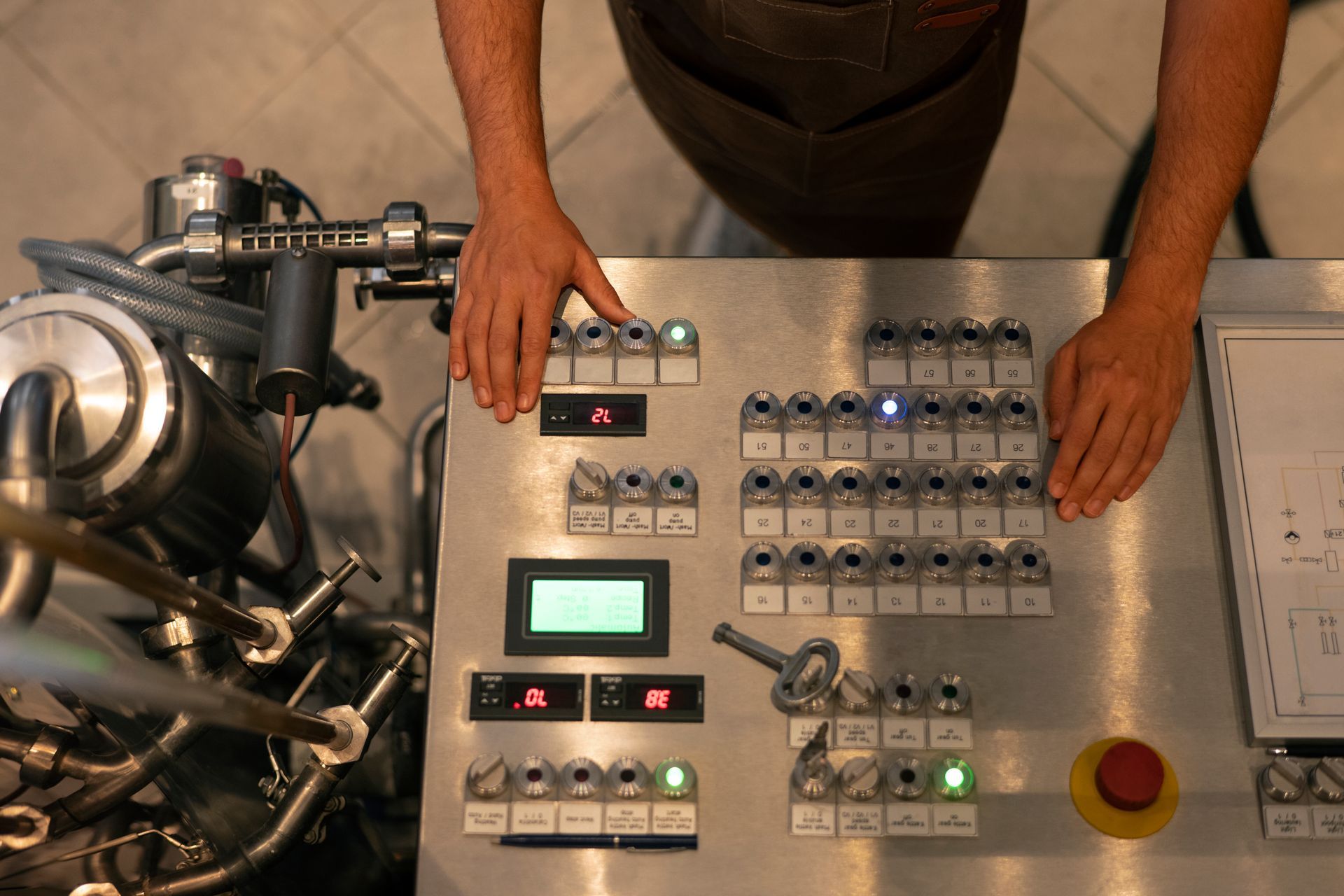 A man is pressing buttons on a control panel