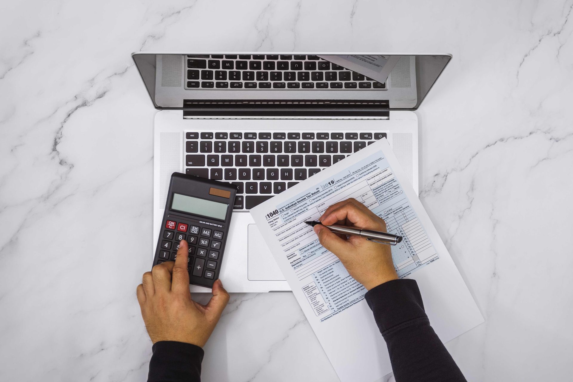 Filling Up Tax Form and Using Calculator — Fayetteville, NC — Angels' Taxes
