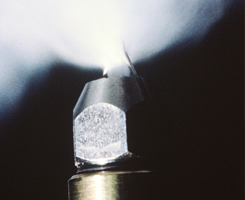 A close up of a metal object with a light coming out of it