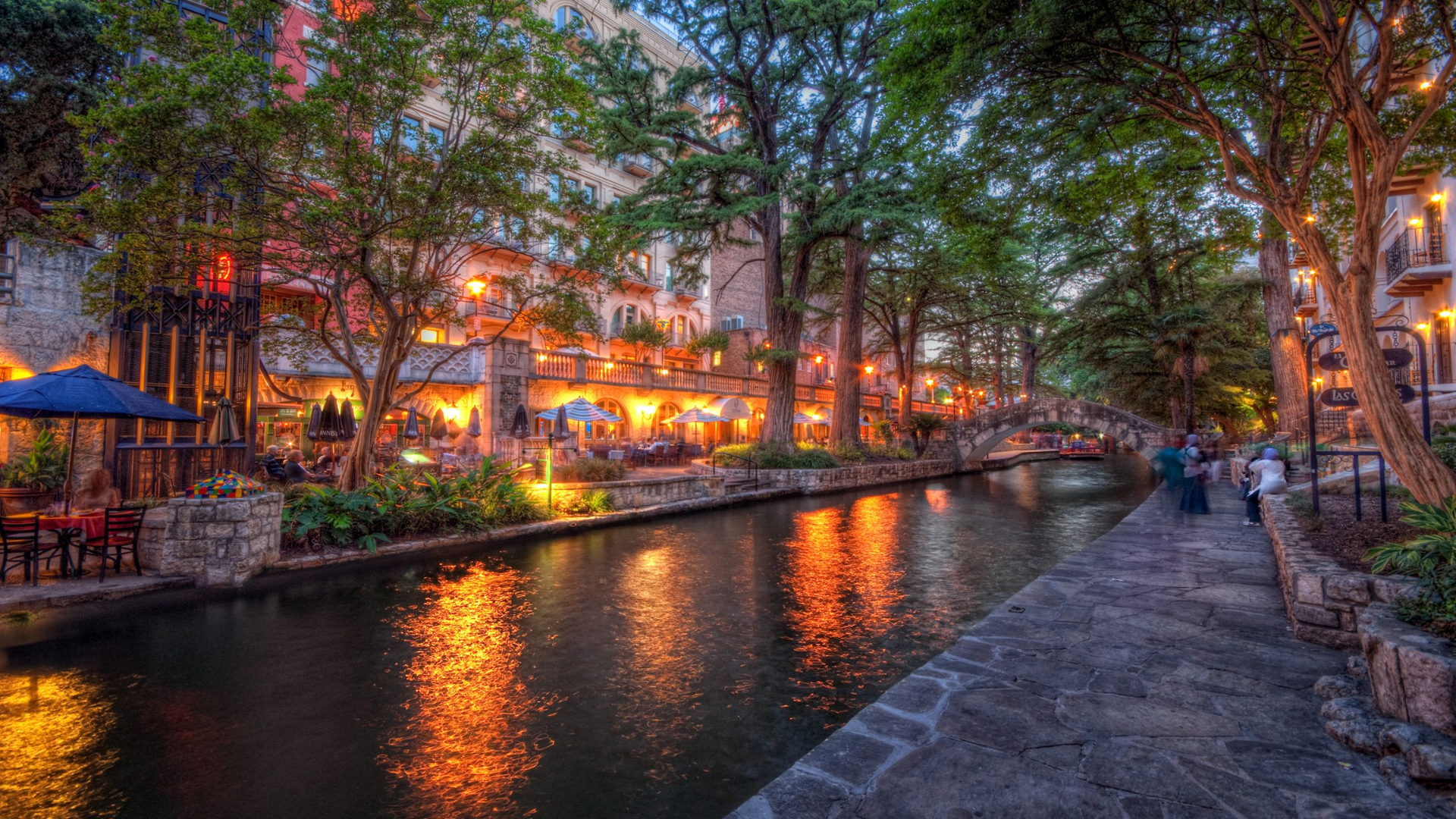 San Antonio Riverwalk at sunset, featuring restaurants and tour boats, a must-visit attraction