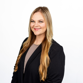 Kathryn Stansbury sitting at a desk at Land and Sea Travel