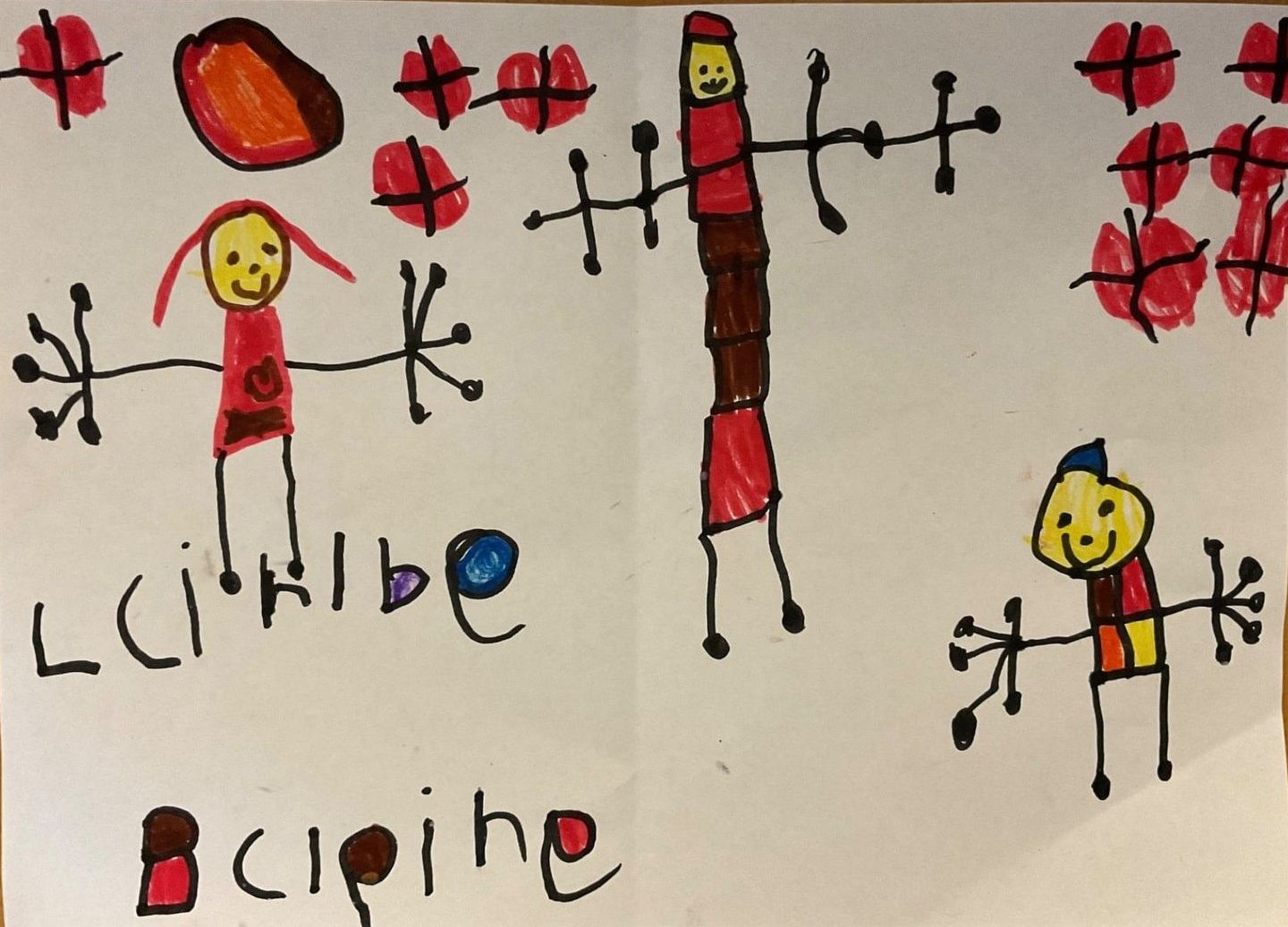 Child's drawing of three stick figures in red clothes, surrounded by red shapes. — Kinburra Preschool (Kincumber) in Kincumber, NSW