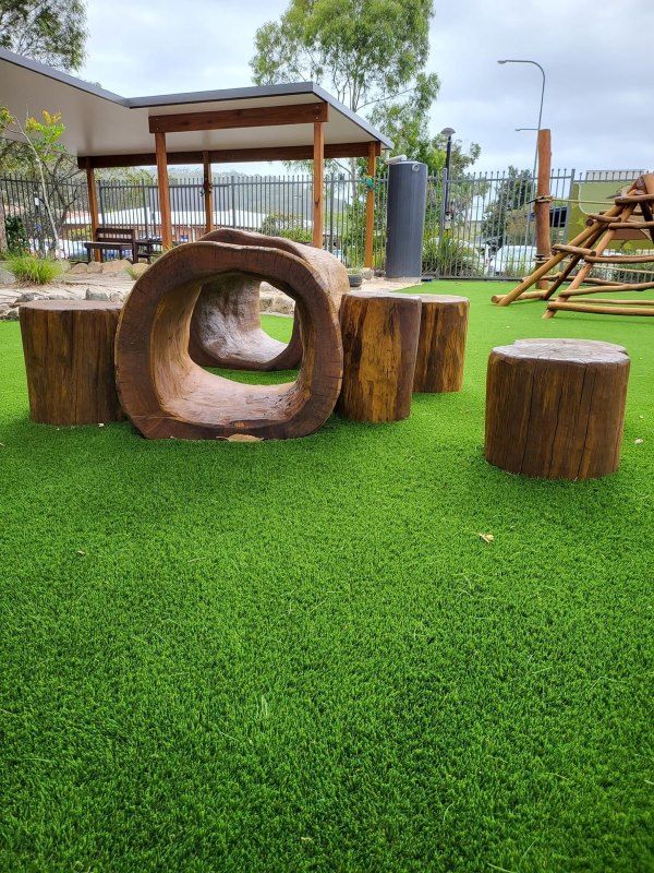A Wooden Tunnel Made Out of Tree Stumps in a Playground  — Kinburra Preschool (Kincumber) in Kincumber, NSW