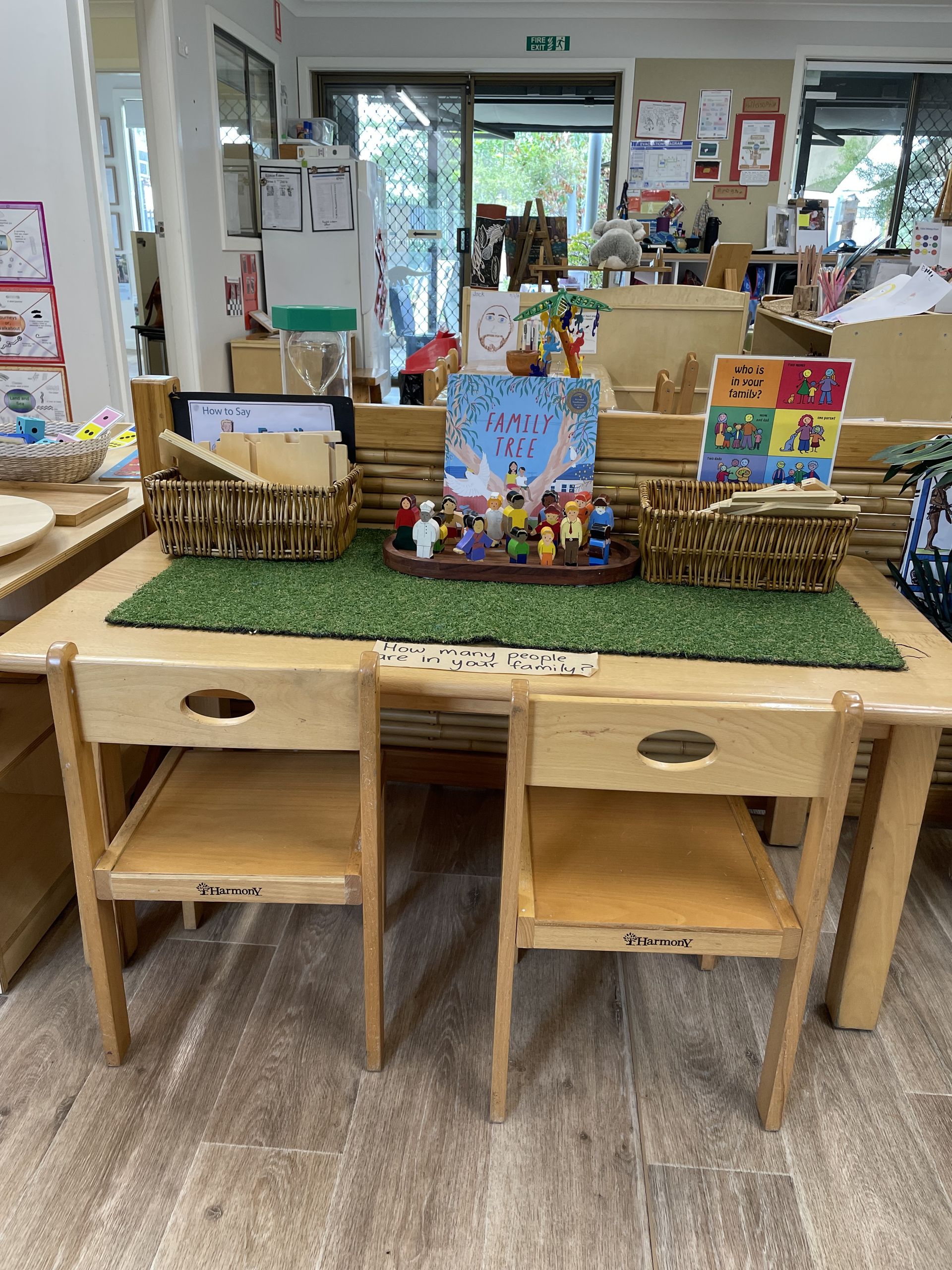 Child-sized wooden table and chairs with toys and books displayed for early learning. — Kinburra Preschool (Kincumber) in Kincumber, NSW