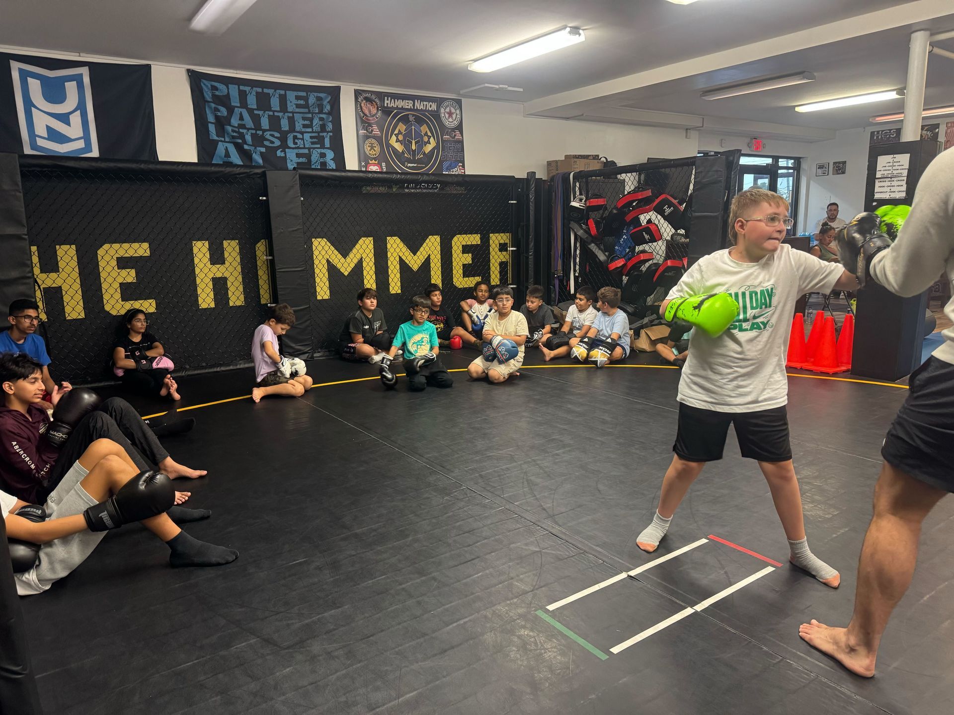 Kids practicing controlled grappling in Youth Jiu Jitsu class at Hamptons Jiu-Jitsu in Southampton.