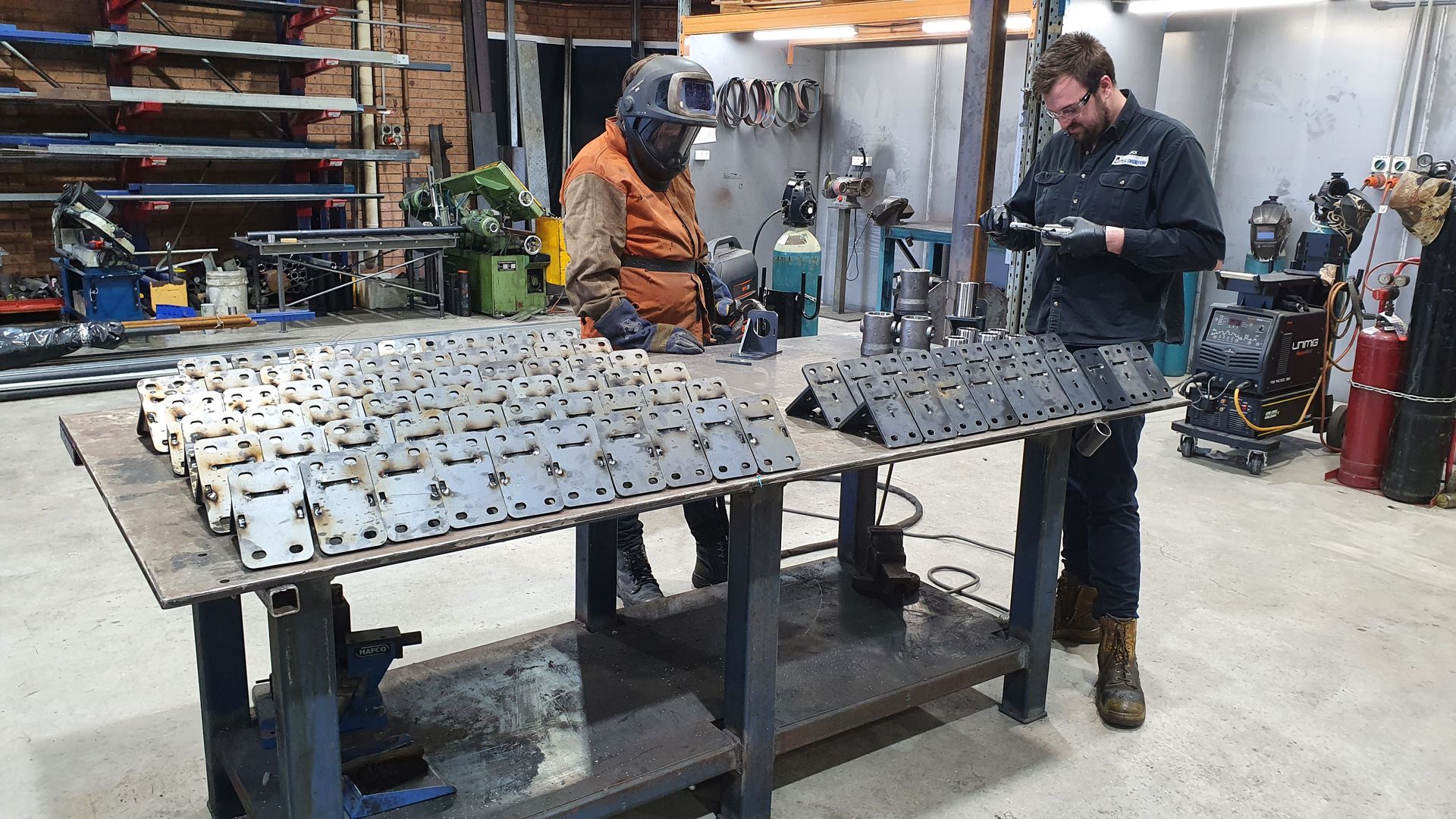 Two People Work in A Metal Workshop, Assembling Small Metal Parts — Real Engineering in West Gosford, NSW