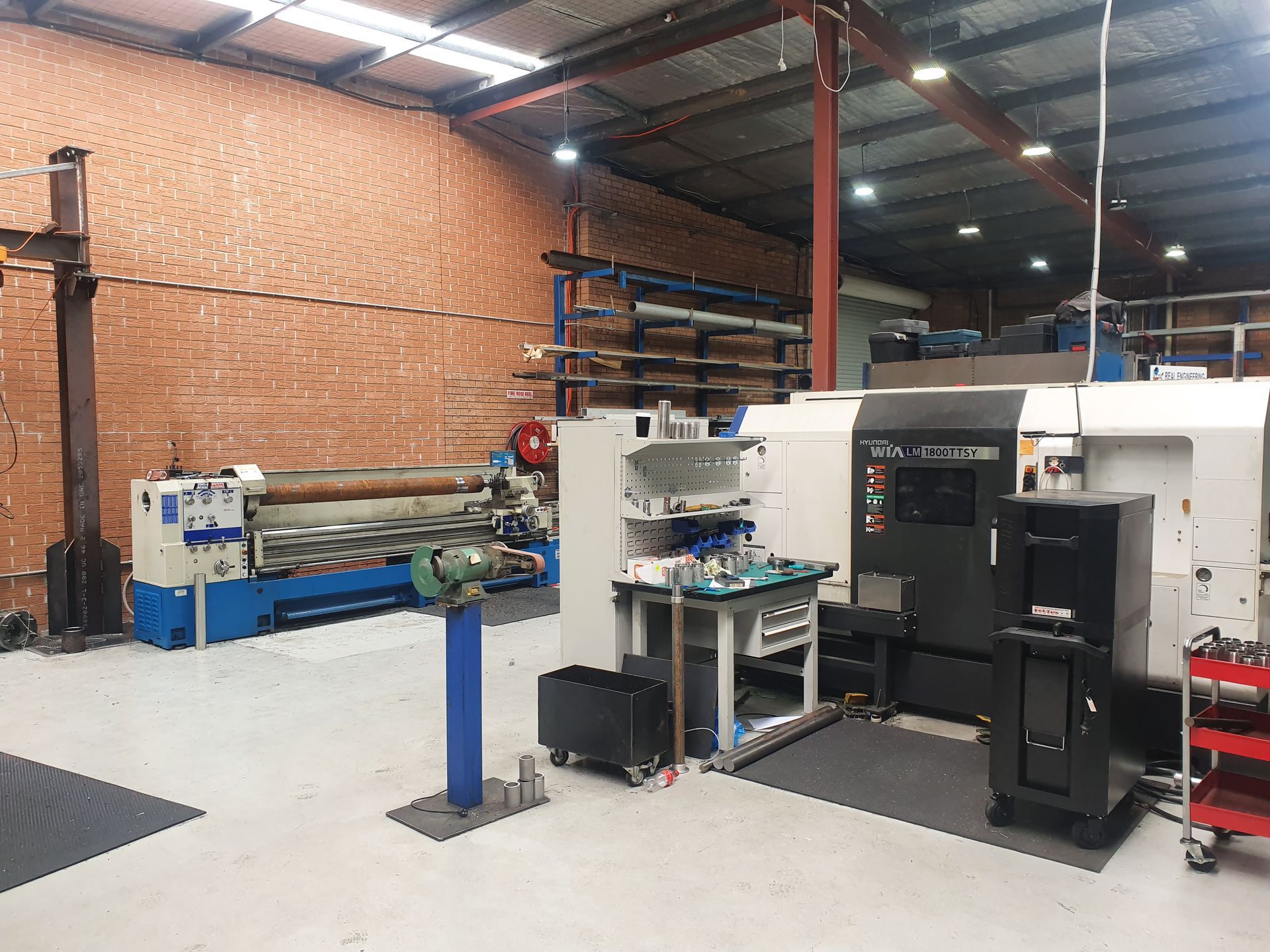 A Bright Machine Shop Workspace Featuring a Large Industrial Lathe, a Cnc Machine — Real Engineering in West Gosford, NSW