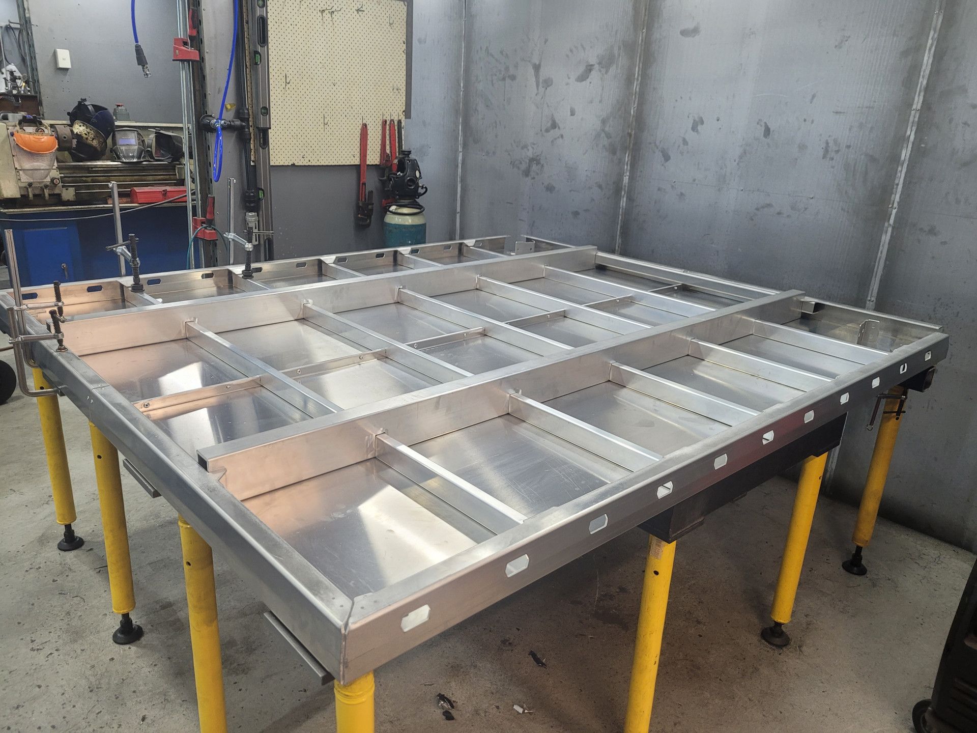 A Metal Aircraft Wing Skeleton Assembly Rests on A Yellow-Legged Workbench — Real Engineering in West Gosford, NSW