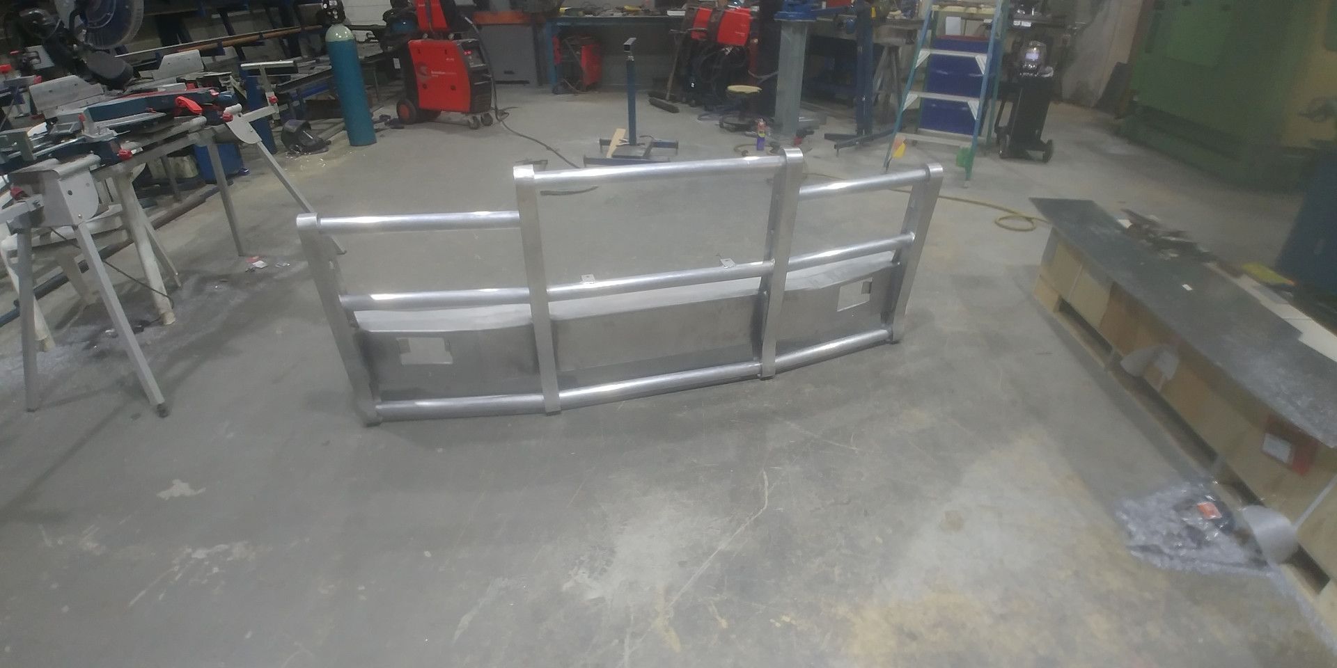 A Large, Shiny Aluminum Bumper Guard Stands on The Concrete Floor — Real Engineering in West Gosford, NSW