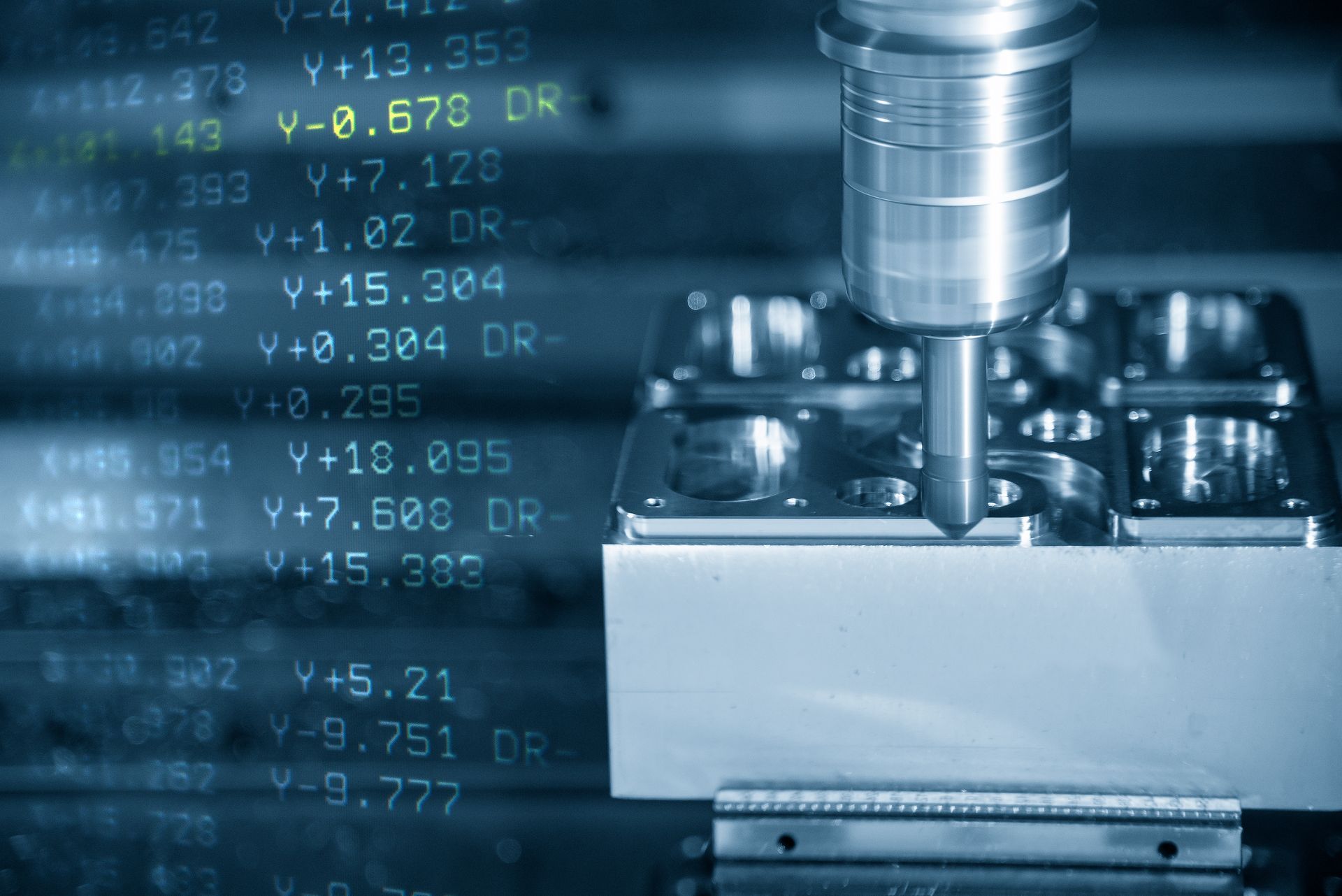 CNC machine cutting a metal block with a blue digital data overlay in the background — Real Engineering In Gosford, NSW