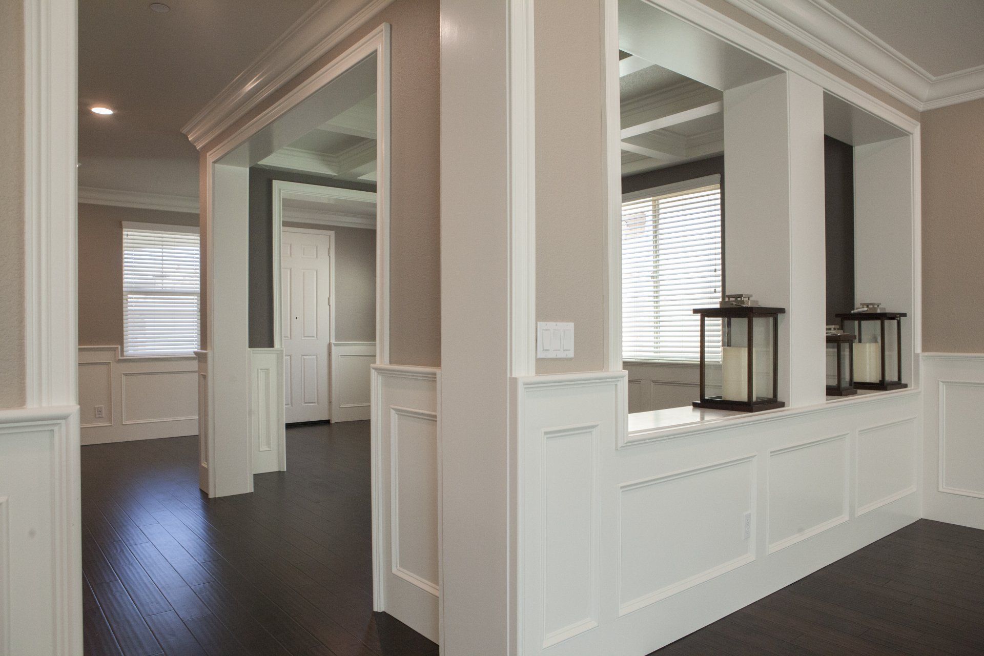 Interior with white trim, dark floors, and built-in shelves holding lanterns.