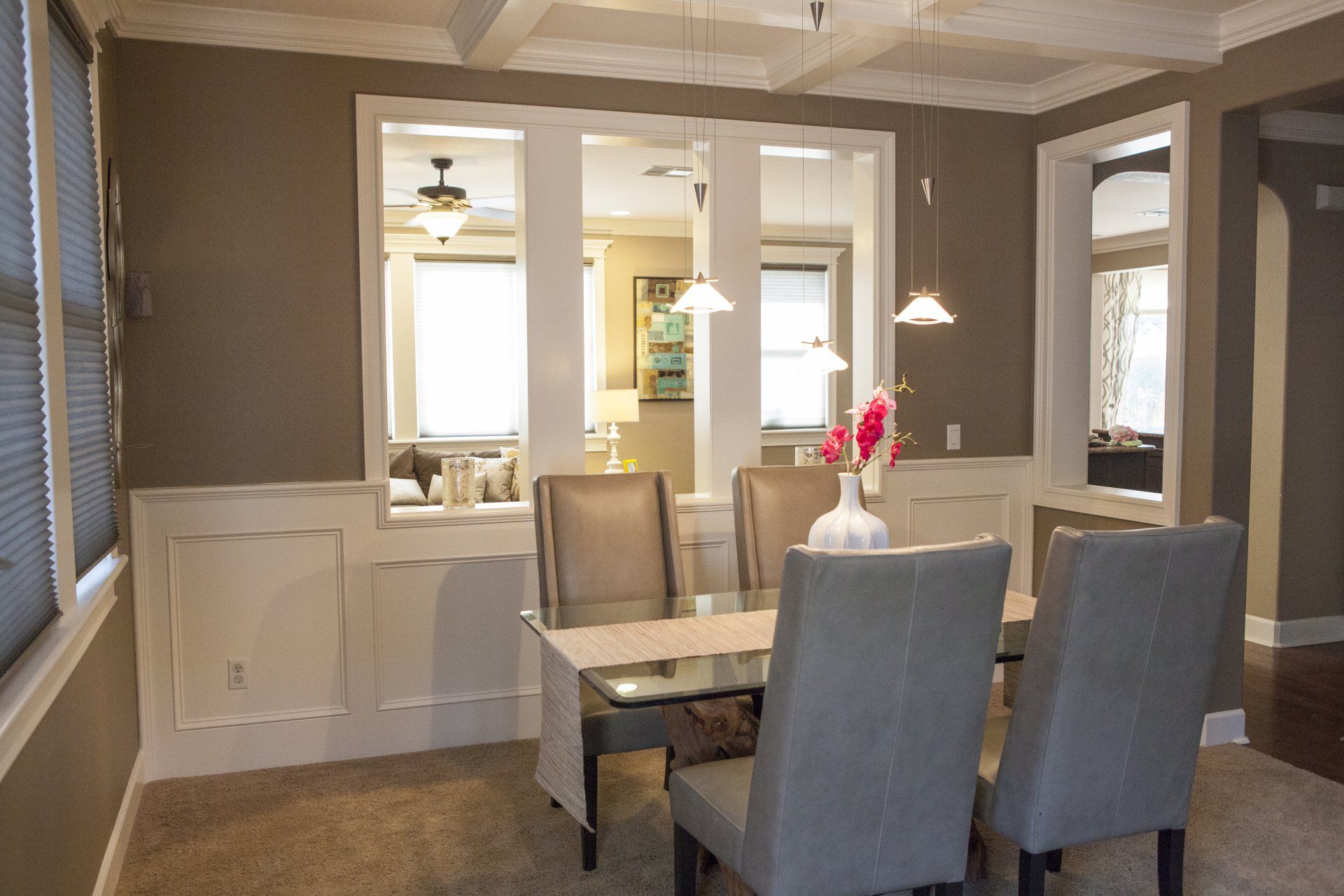 Dining room with a table, chairs, and decorative wall panels.