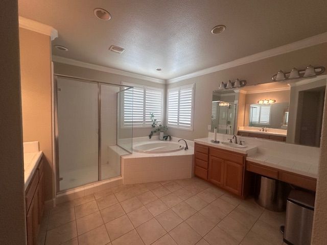 Spacious master bathroom with shower, tub, double vanity, and a window with shutter blinds.