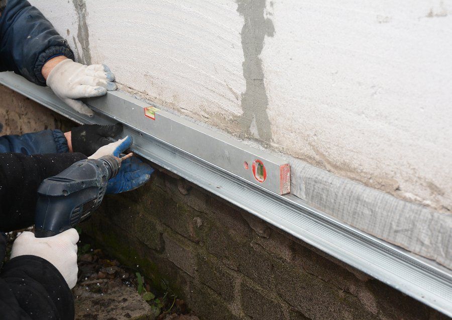 worker measuring the wall