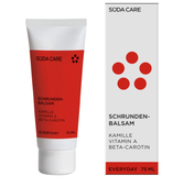 Rode en witte SODA CARE Schunden-Balsam tube en bijpassende doos met rode stippen