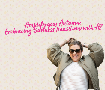A woman poses cheerfully. Text reads: Amplify your Autumn Embracing Business Transitions with A2