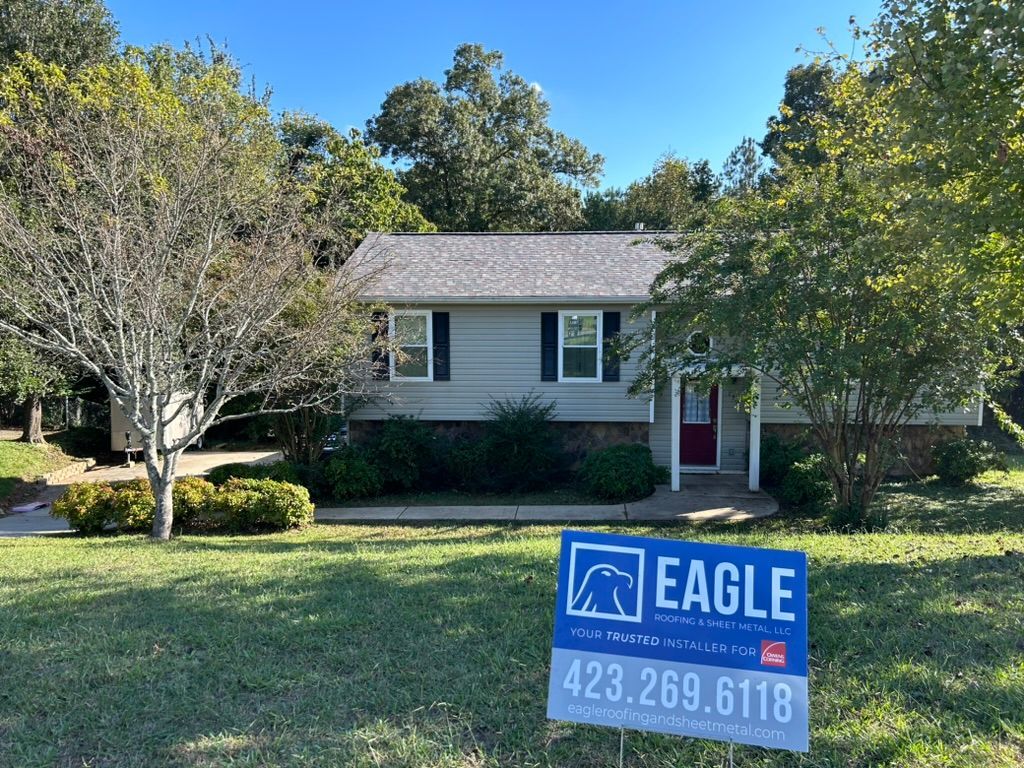 A house with a for sale sign in front of it