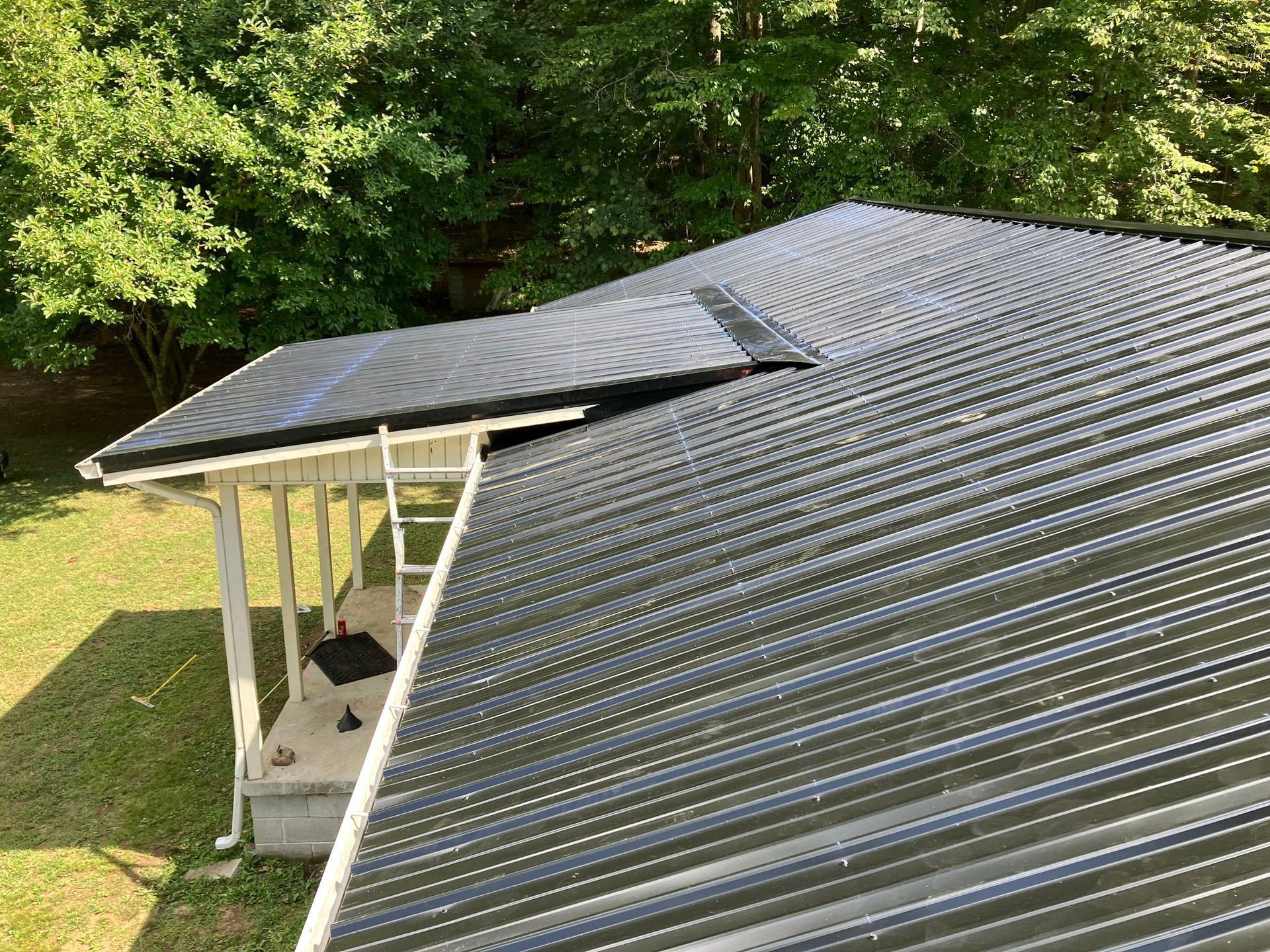 A metal roof is being installed on a house.