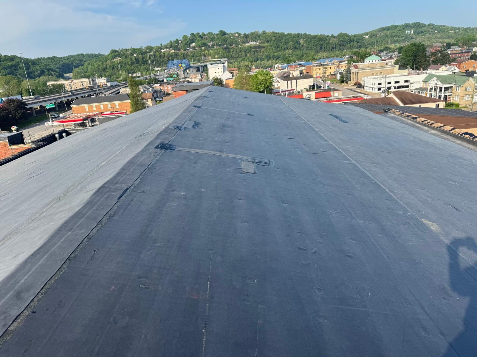 The roof of a building with a view of a city.