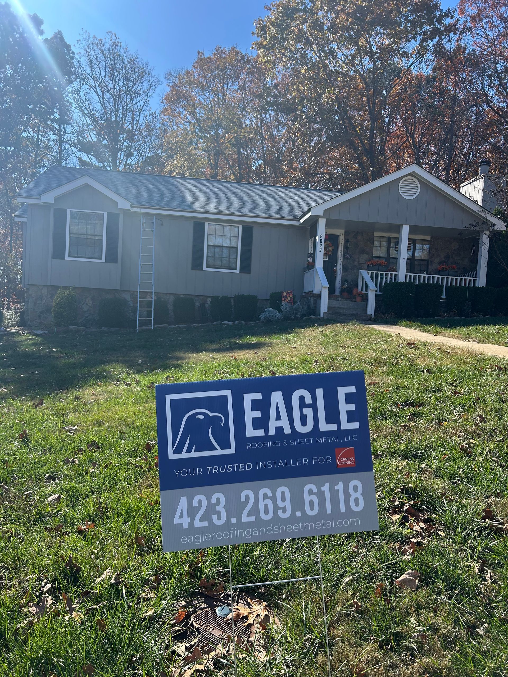 A house with a for sale sign in front of it.