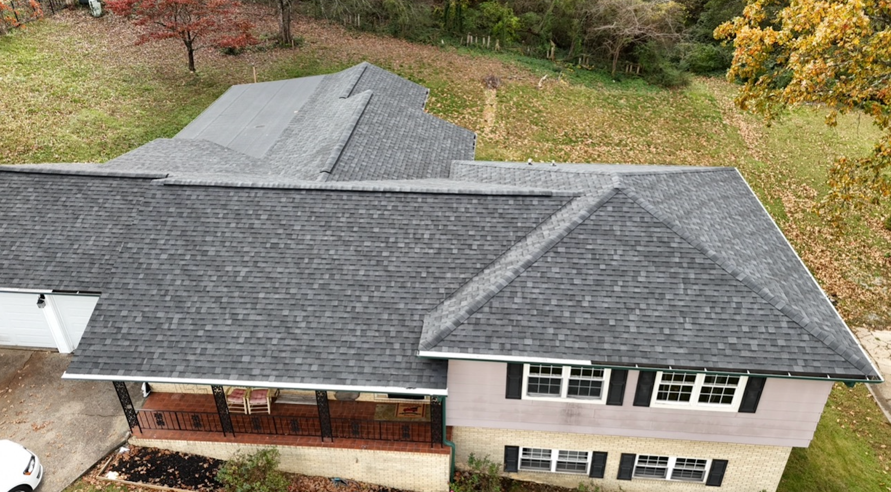 An aerial view of a house with a new roof.